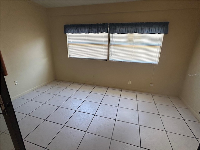 tiled spare room with a wealth of natural light