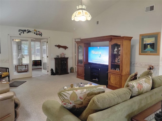 carpeted living room featuring vaulted ceiling