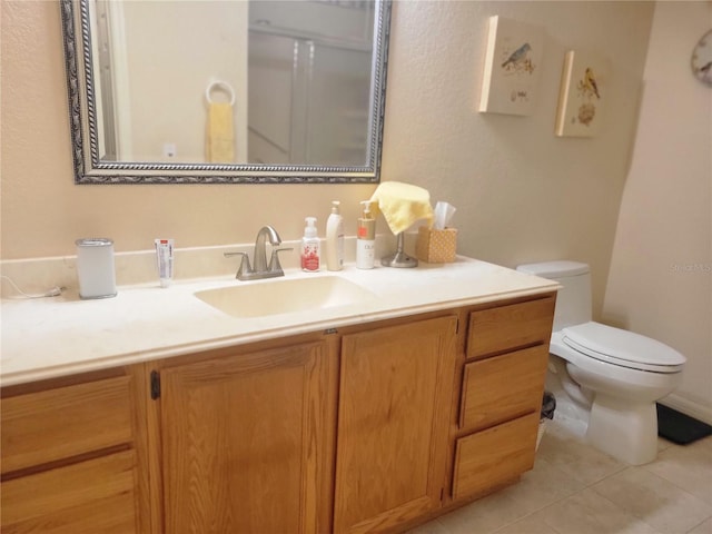 bathroom with tile patterned floors, vanity, and toilet