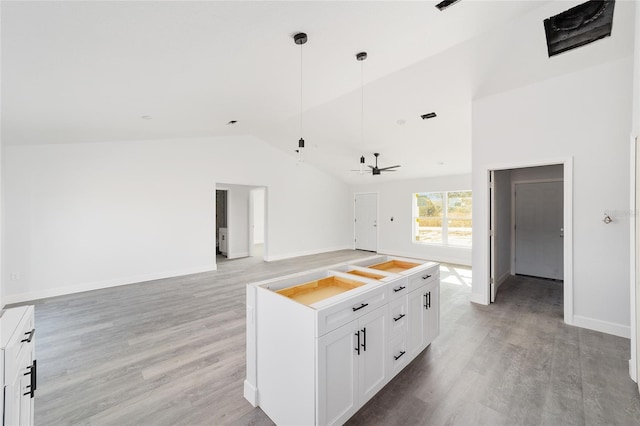 kitchen with white cabinets, ceiling fan, light wood-type flooring, and lofted ceiling