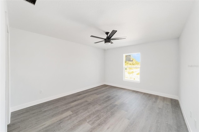 spare room featuring ceiling fan and hardwood / wood-style flooring