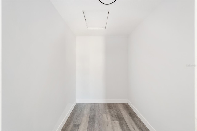 walk in closet with light hardwood / wood-style floors