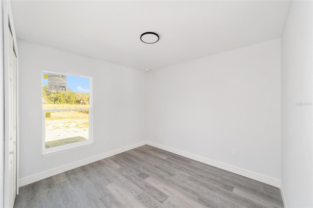 unfurnished room with a healthy amount of sunlight and light hardwood / wood-style floors