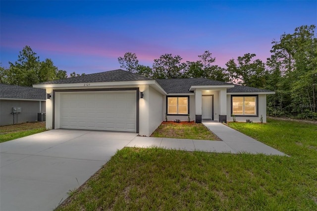 55 Locust Loop Cir, Ocala, FL 34472 - view of front facade featuring an attached garage, stucco siding, a yard, concrete driveway, and roof with shingles