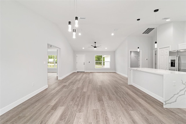 55 Locust Loop Cir, Ocala, FL 34472 - unfurnished living room featuring plenty of natural light, light wood finished floors, ceiling fan, recessed lighting, and vaulted ceiling