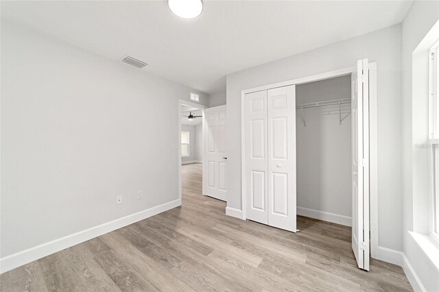 55 Locust Loop Cir, Ocala, FL 34472 - unfurnished bedroom featuring light wood-style flooring and a closet