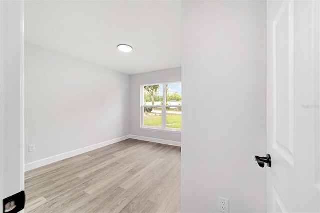 55 Locust Loop Cir, Ocala, FL 34472 - unfurnished room with light wood-style flooring and baseboards