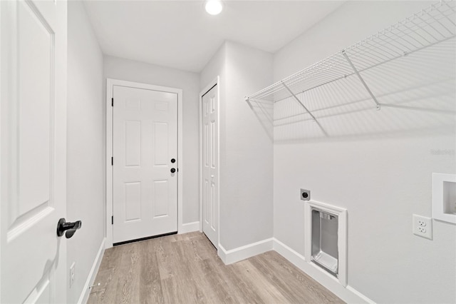 55 Locust Loop Cir, Ocala, FL 34472 - laundry room with hookup for an electric dryer and light wood-type flooring