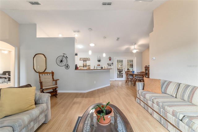 living room with french doors and light hardwood / wood-style floors