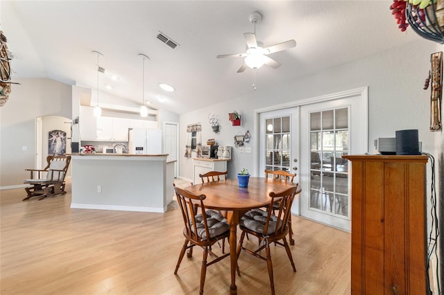 dining area featuring french doors, lofted ceiling, sink, light hardwood / wood-style flooring, and ceiling fan