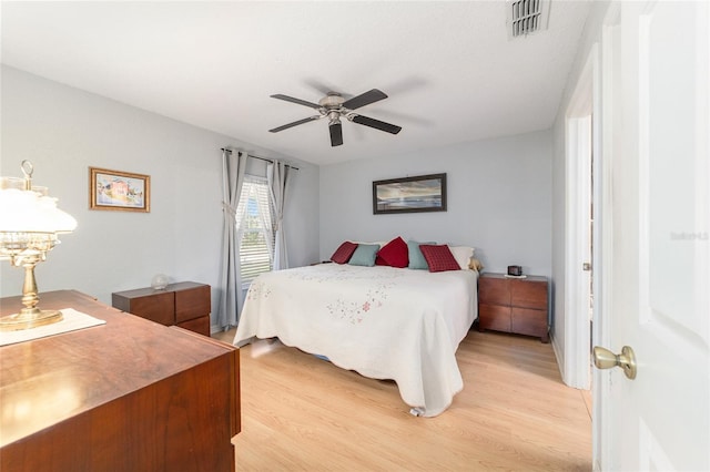 bedroom with light hardwood / wood-style flooring and ceiling fan