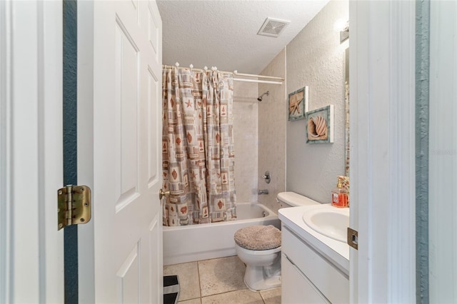 full bathroom with shower / bath combination with curtain, vanity, toilet, tile patterned floors, and a textured ceiling