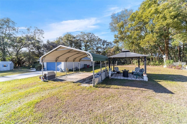 view of vehicle parking with a yard, a gazebo, and a carport