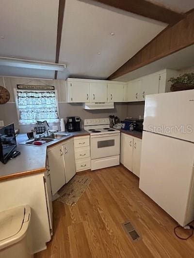 kitchen featuring white cabinetry, lofted ceiling, sink, light hardwood / wood-style floors, and white appliances