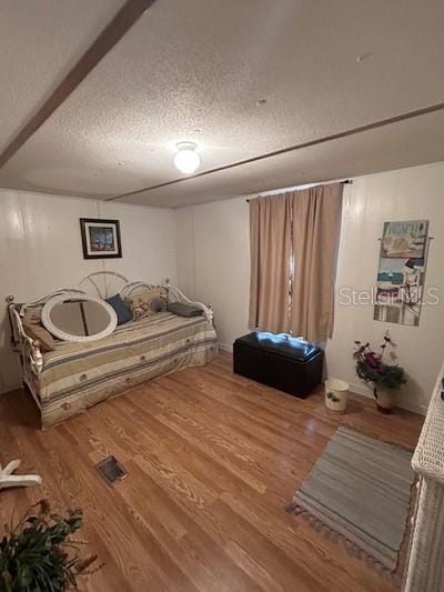 sitting room featuring hardwood / wood-style flooring and a textured ceiling