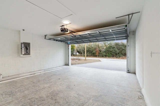 garage featuring electric panel and a garage door opener