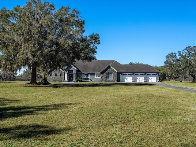 single story home with a garage and a front yard