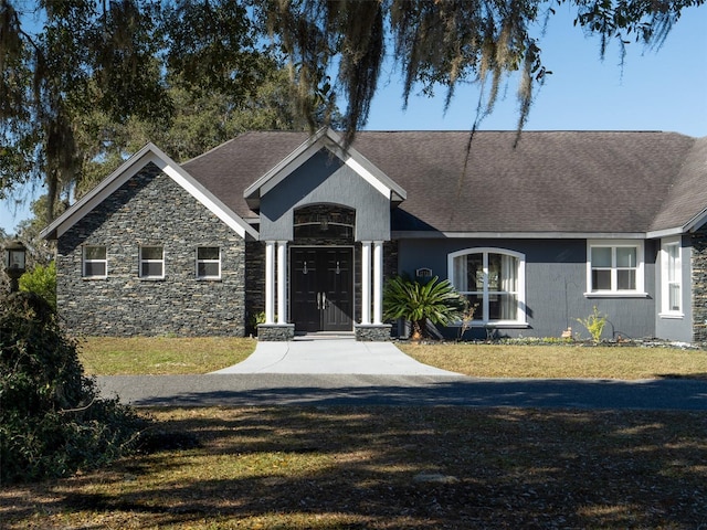 ranch-style home featuring a front yard