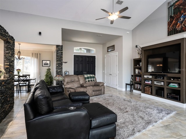 living room featuring ceiling fan with notable chandelier and vaulted ceiling