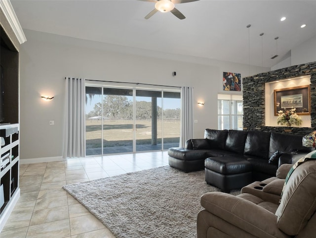 tiled living room featuring ceiling fan and vaulted ceiling