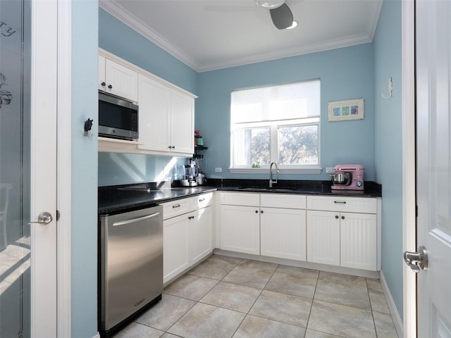 kitchen with white cabinetry, sink, and crown molding