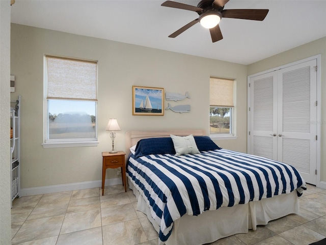 tiled bedroom with a closet and ceiling fan