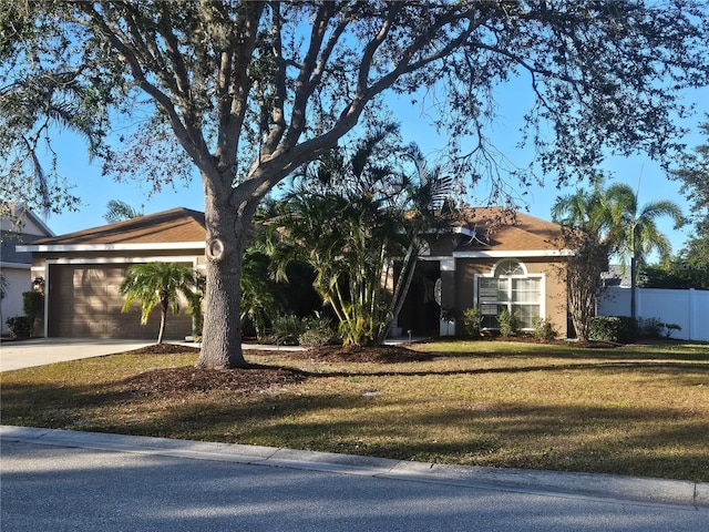 ranch-style house with a front yard and a garage