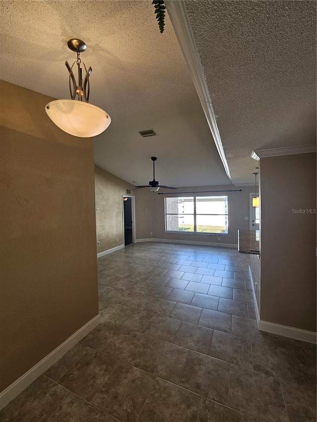 empty room featuring a textured ceiling, ceiling fan, and crown molding