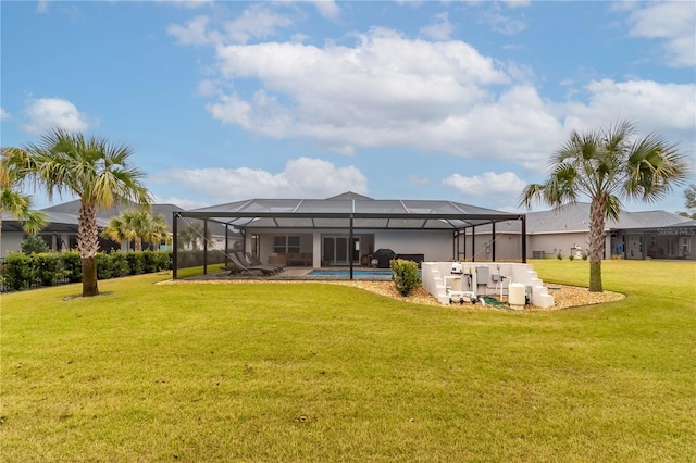 back of house with glass enclosure, a pool, and a lawn