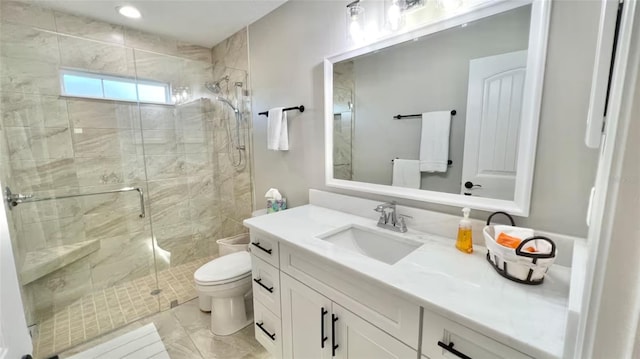 bathroom with toilet, vanity, and walk in shower