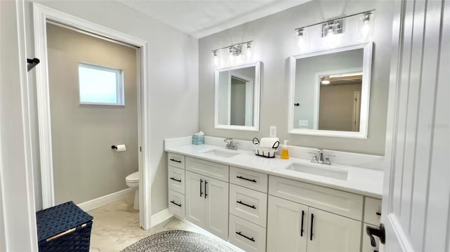 bathroom featuring toilet and vanity