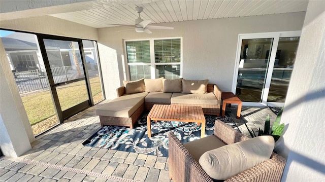 sunroom featuring ceiling fan and a wealth of natural light