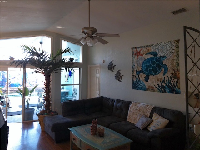 living room with ceiling fan, wood-type flooring, and lofted ceiling