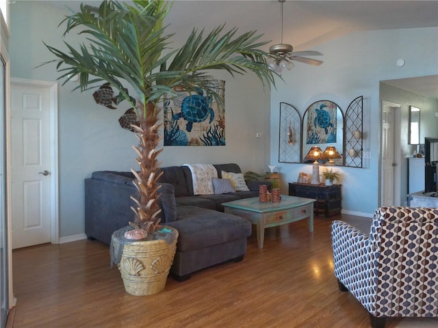 living room featuring wood-type flooring and ceiling fan