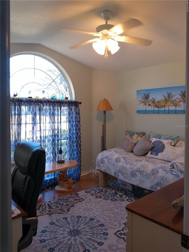 bedroom with wood-type flooring, vaulted ceiling, and ceiling fan