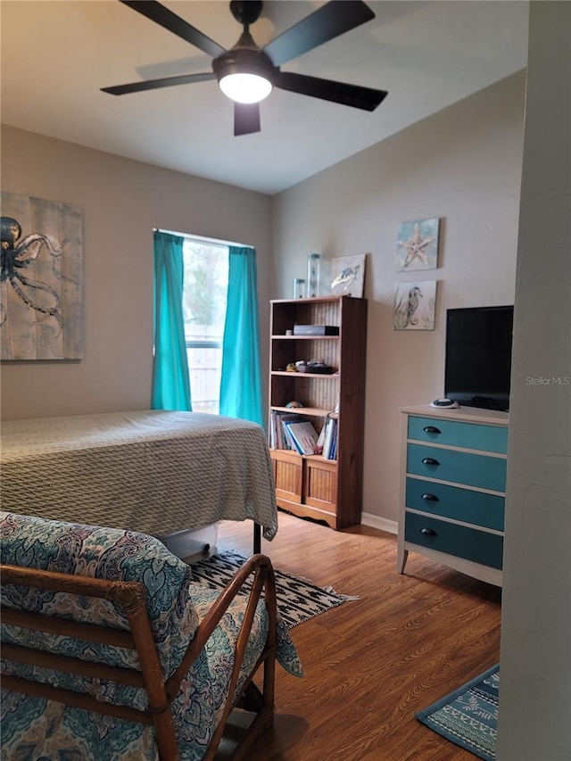 bedroom featuring hardwood / wood-style floors and ceiling fan