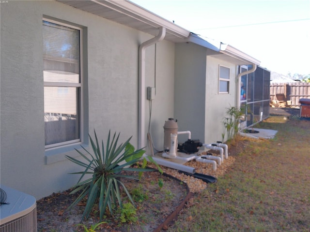 view of side of home with central air condition unit