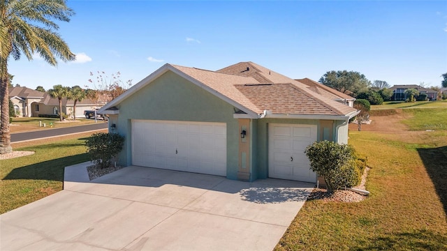 single story home with a front yard and a garage