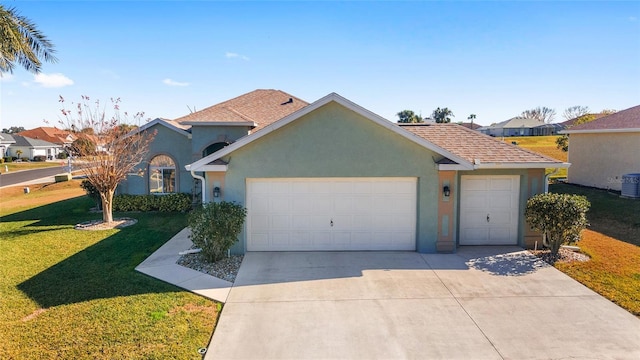 view of front of house with a garage and a front lawn