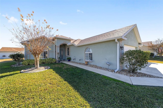 single story home with a garage and a front lawn