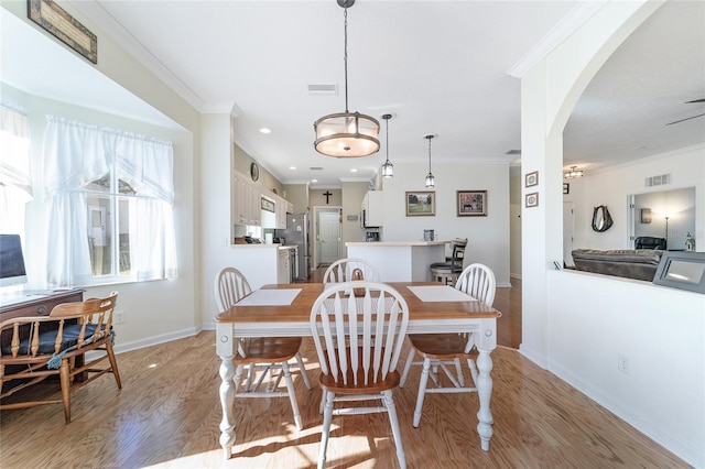 dining room featuring ceiling fan, light hardwood / wood-style flooring, and ornamental molding