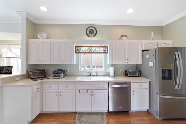 kitchen with white cabinets, stainless steel appliances, a wealth of natural light, and sink