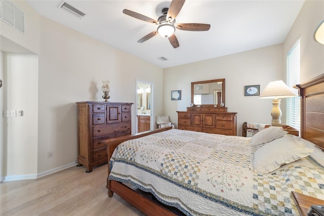 bedroom with ensuite bathroom, ceiling fan, and light wood-type flooring