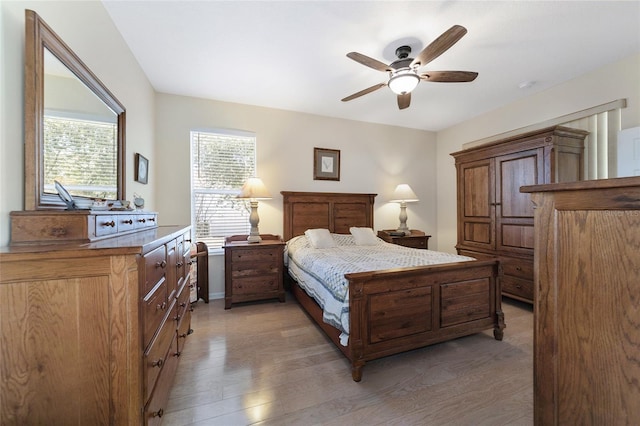 bedroom with ceiling fan and dark hardwood / wood-style floors