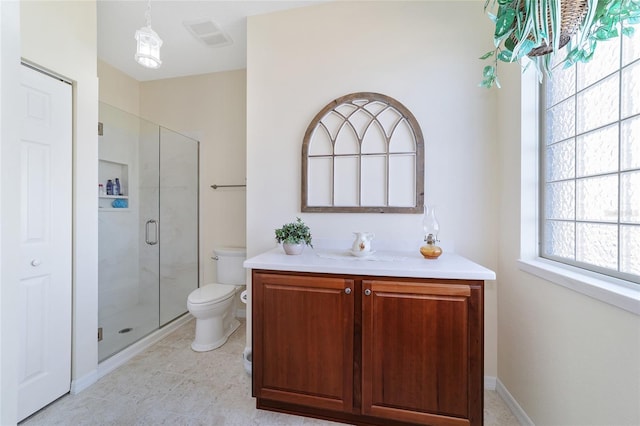 bathroom with vanity, a shower with shower door, and toilet