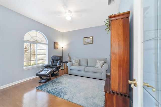 living room featuring ceiling fan and hardwood / wood-style floors