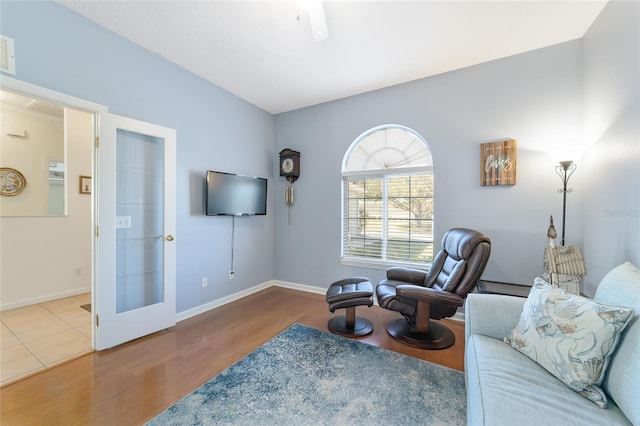 living area with wood-type flooring and french doors