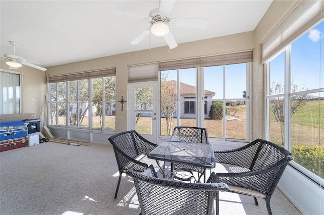 sunroom featuring ceiling fan and plenty of natural light