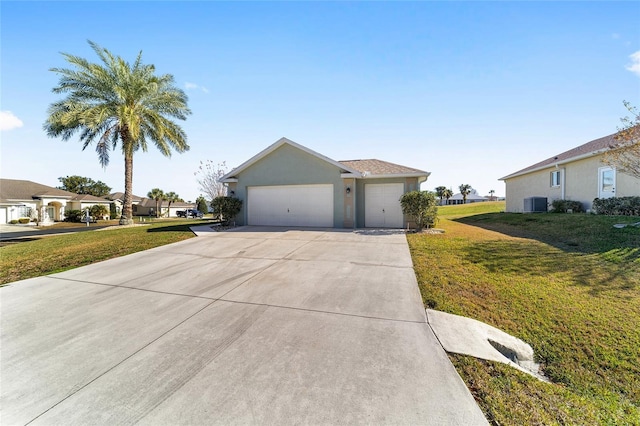 view of front of home featuring central AC, a garage, and a front lawn