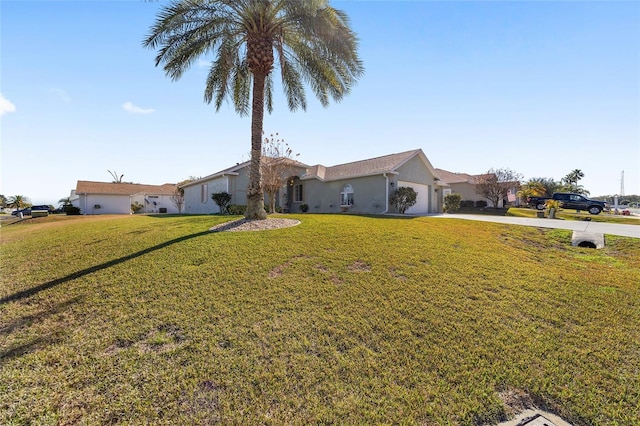 ranch-style home featuring a front lawn and a garage